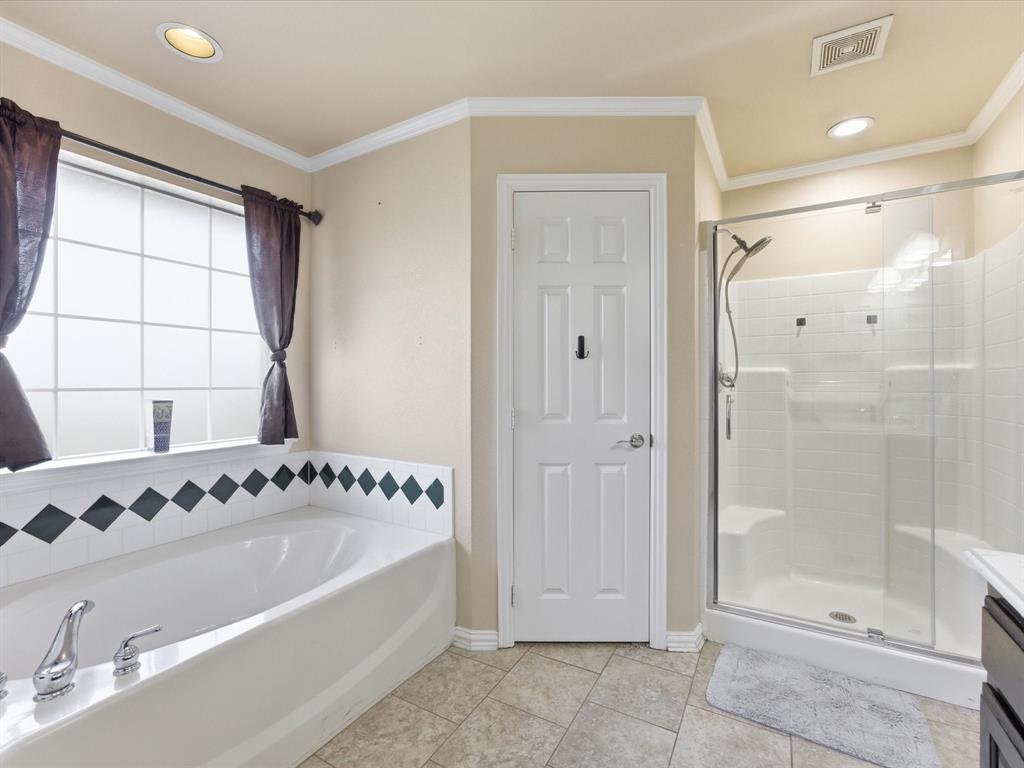 10000 Fireside Lane Forney, TX 75126 - Photo 28 of 40 Master bathroom with a stall shower, a garden tub, vanity, recessed lighting, and ornamental molding
