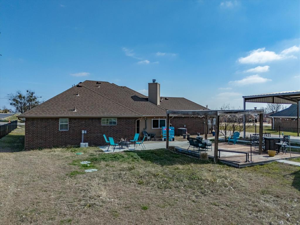 10000 Fireside Lane Forney, TX 75126 - Photo 9 of 40 Rear view of house with a patio, a pergola, brick siding, and a chimney