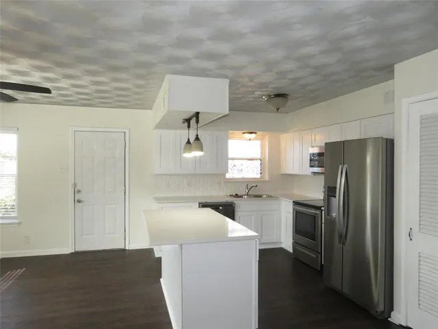 a kitchen with a refrigerator sink and stove