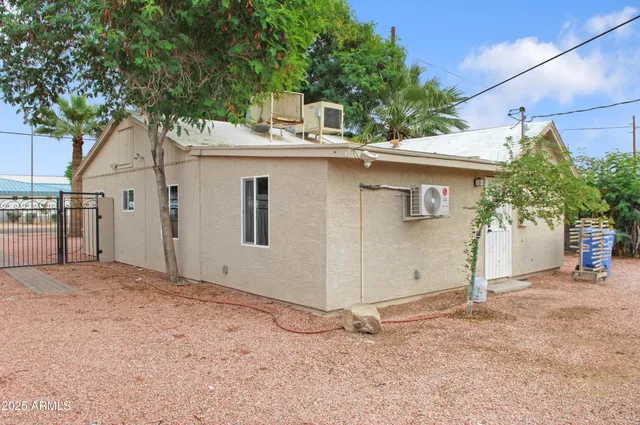a view of a house with a tree and a yard