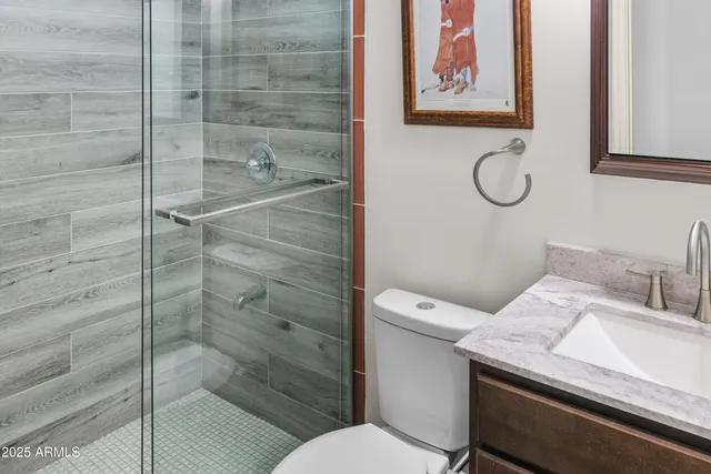 an empty room with wooden floor and ceiling fan