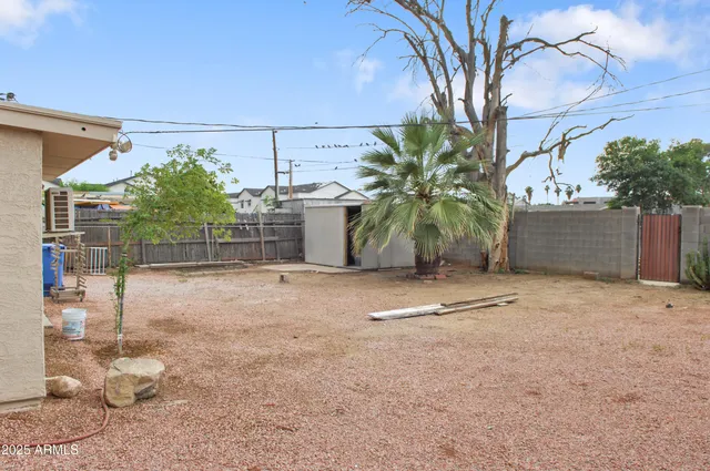 a view of a house with a tree and a yard
