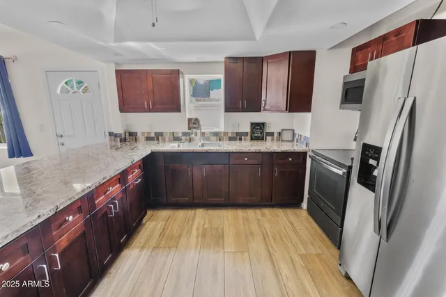 a kitchen with a sink stove and refrigerator