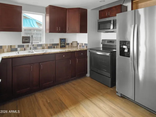 a kitchen with a sink stove and refrigerator