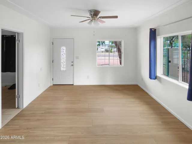 a kitchen with stainless steel appliances granite countertop a sink cabinets and wooden floor