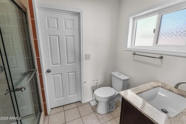 a white toilet sitting next to a bathroom sink