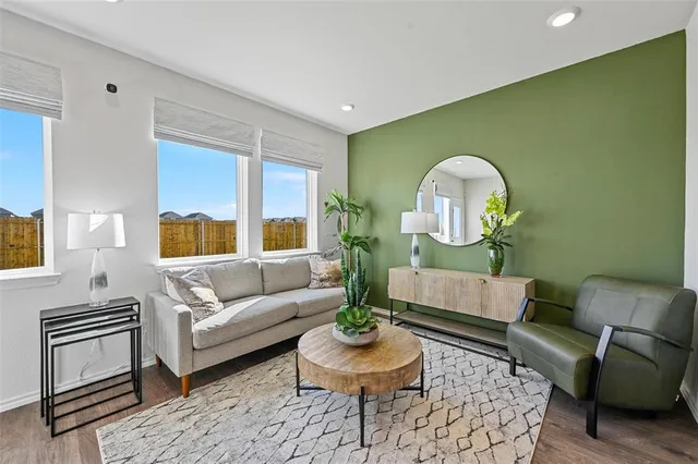 a living room with fireplace furniture and a wooden floor
