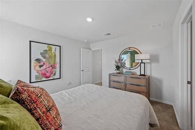 a spacious bedroom with a bed and a window