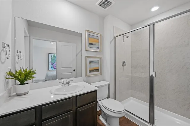 a bedroom with a bed and painting on the wall