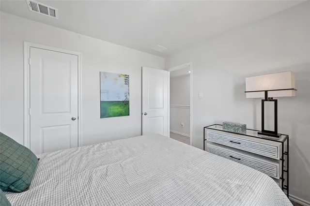 a bedroom with a bed and a table in it