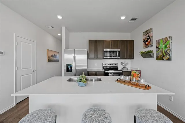 a view of kitchen island sink and living room