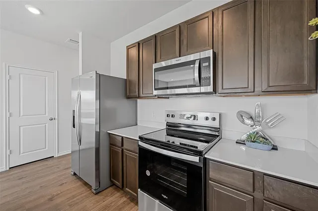 a kitchen with a stove and a microwave