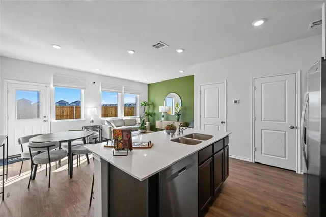 a view of a brick house with wooden fence