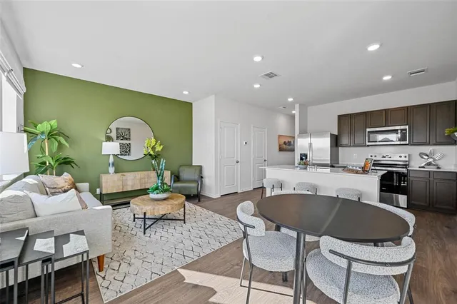 a view of a a dining hall center with furniture and wooden floor