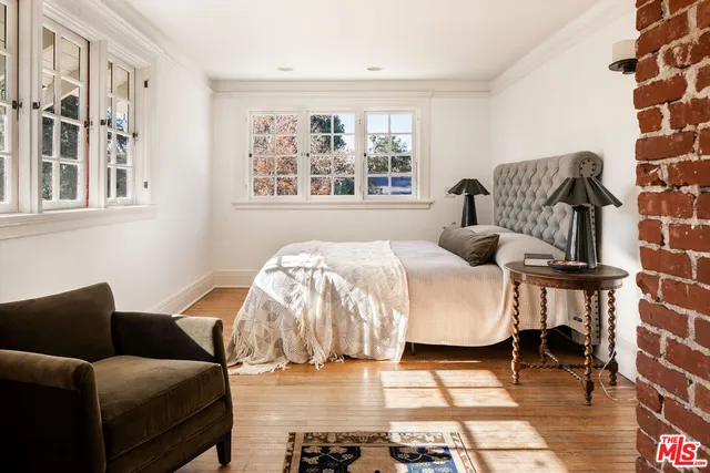 a bedroom with a bed and a couch