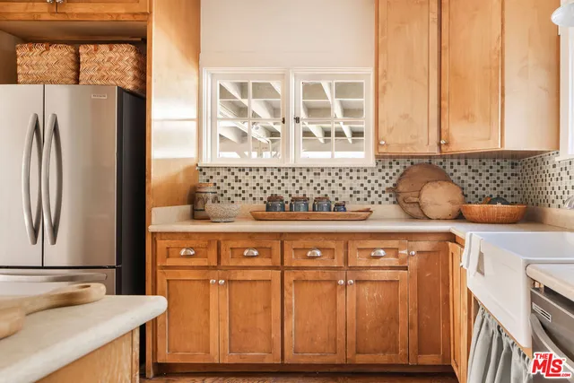 a kitchen with stainless steel appliances granite countertop a refrigerator and a stove