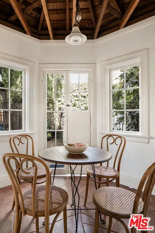 a dining room with furniture a chandelier and wooden floor