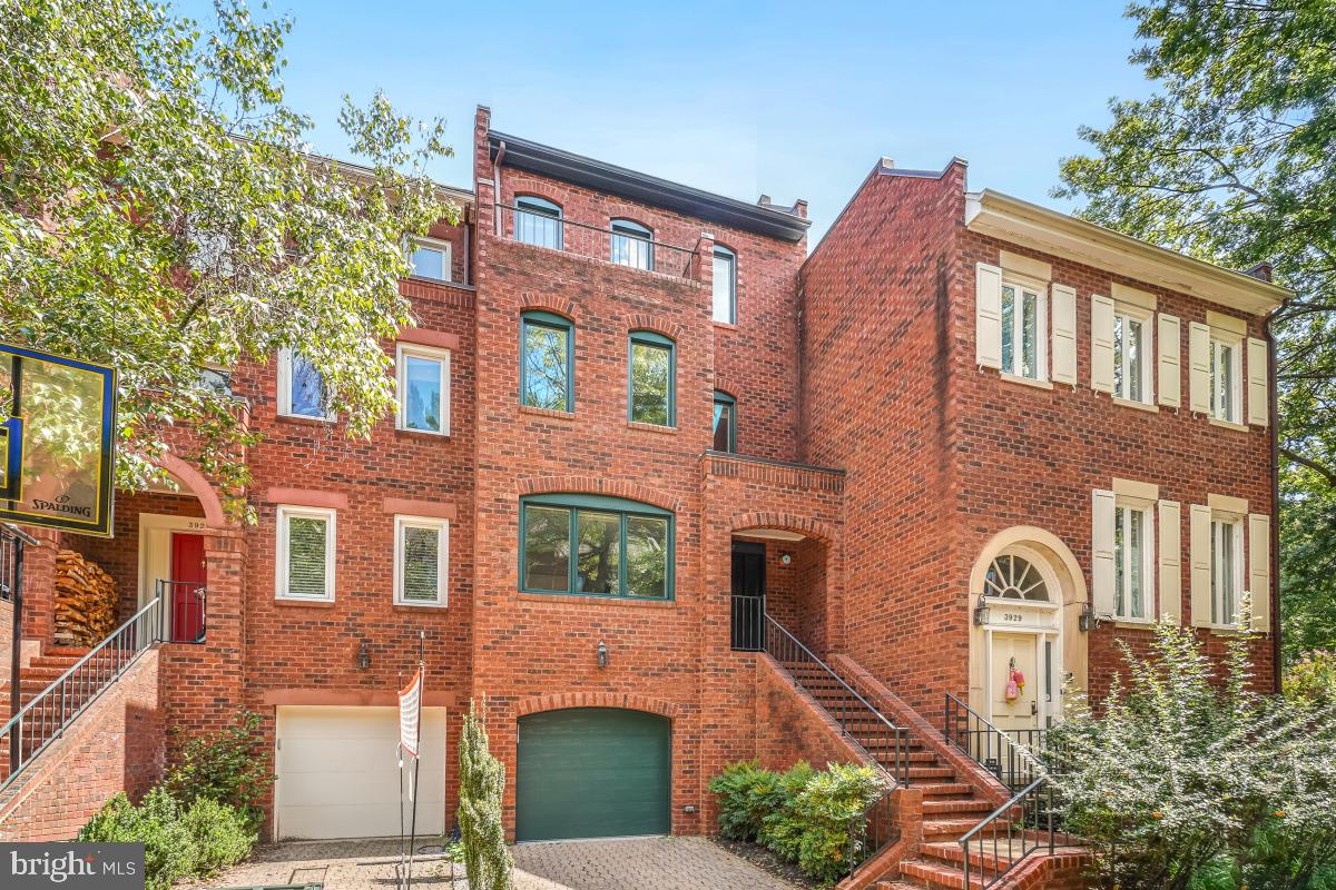 a front view of a residential apartment building with a yard