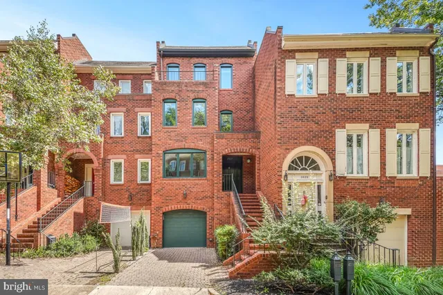 front view of a brick house with a yard