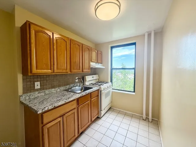 a kitchen that has a sink and a stove