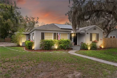 a house view with a potted plant in front of door