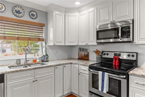 a bathroom with a double vanity sink mirror and shower