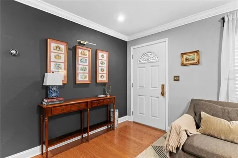 a living room with furniture a flat screen tv and a window
