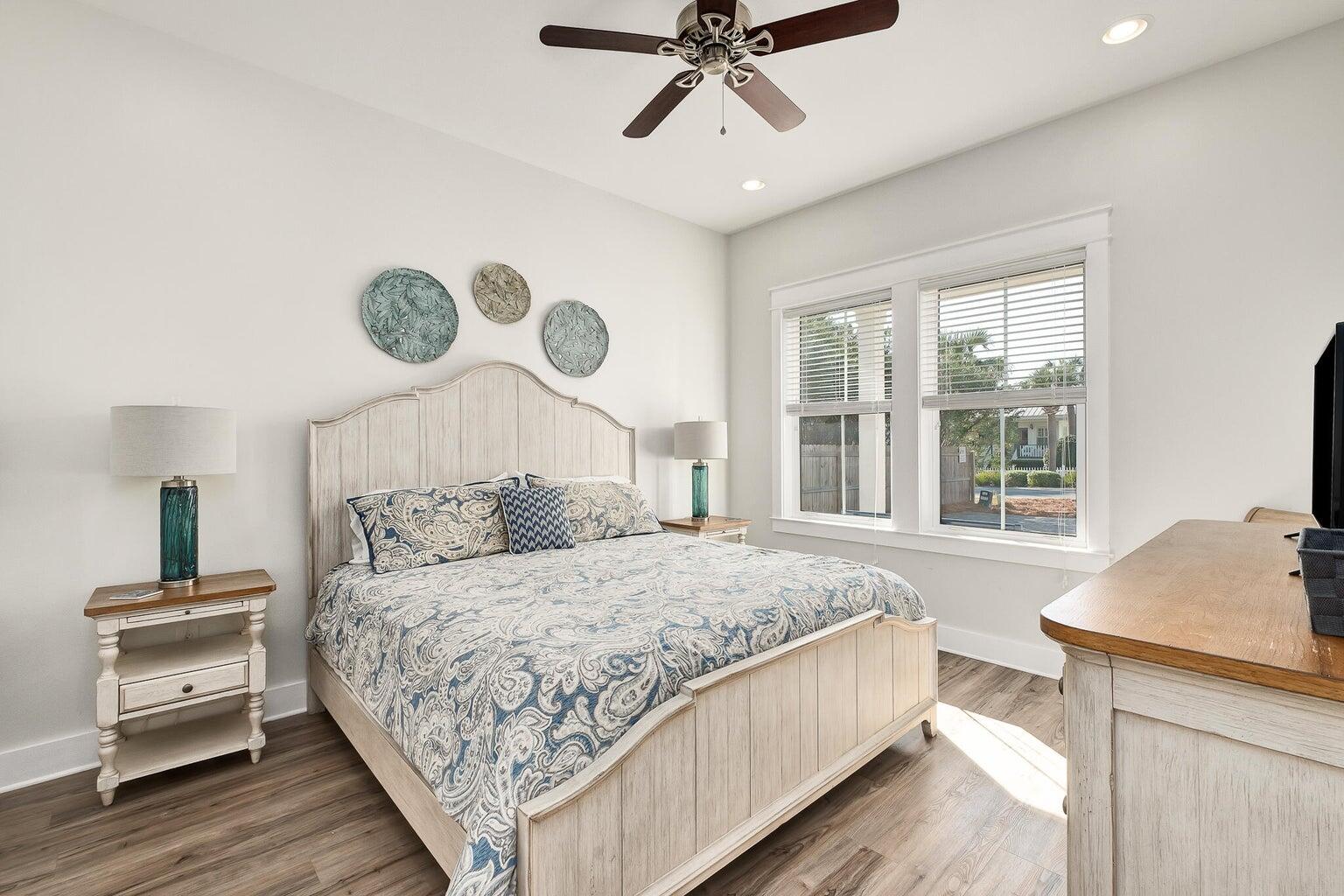 99 Stingray Street Destin, FL 32541 - Photo 12 of 28 a bedroom with a bed and wooden floor