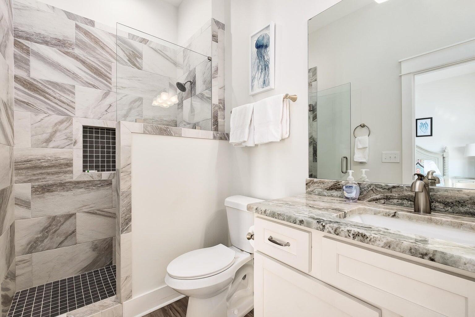 99 Stingray Street Destin, FL 32541 - Photo 18 of 28 a bathroom with a granite countertop sink mirror vanity and toilet
