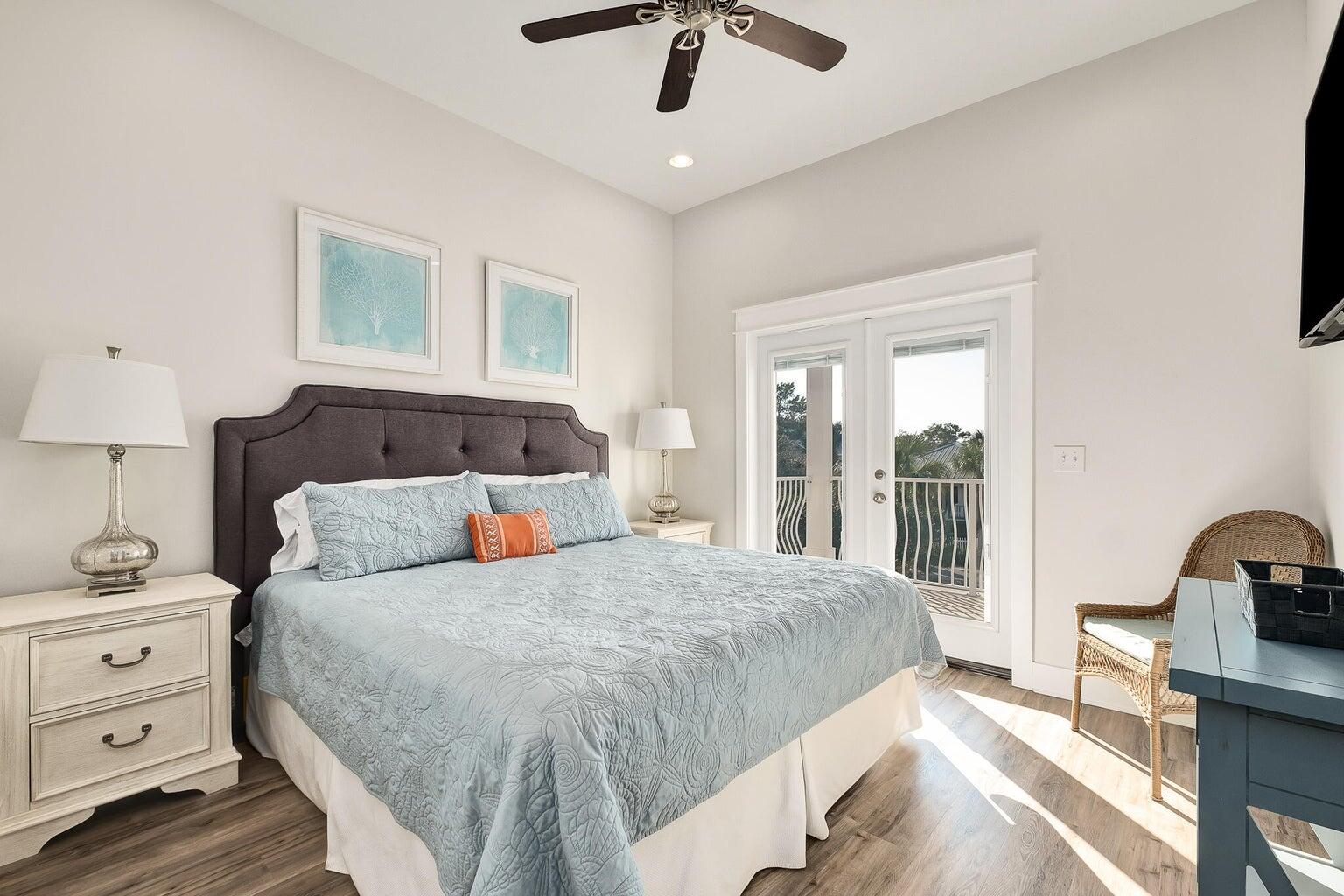 99 Stingray Street Destin, FL 32541 - Photo 19 of 28 a bedroom with a large bed and a chandelier
