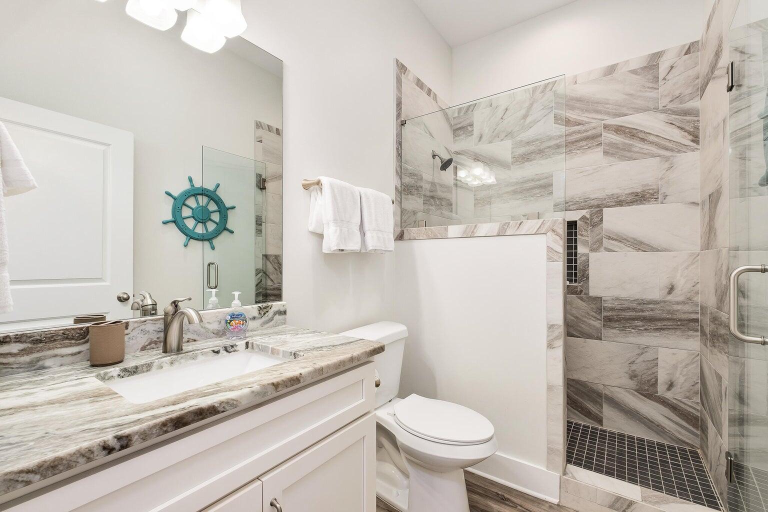 99 Stingray Street Destin, FL 32541 - Photo 20 of 28 a bathroom with a granite countertop sink a toilet and a mirror