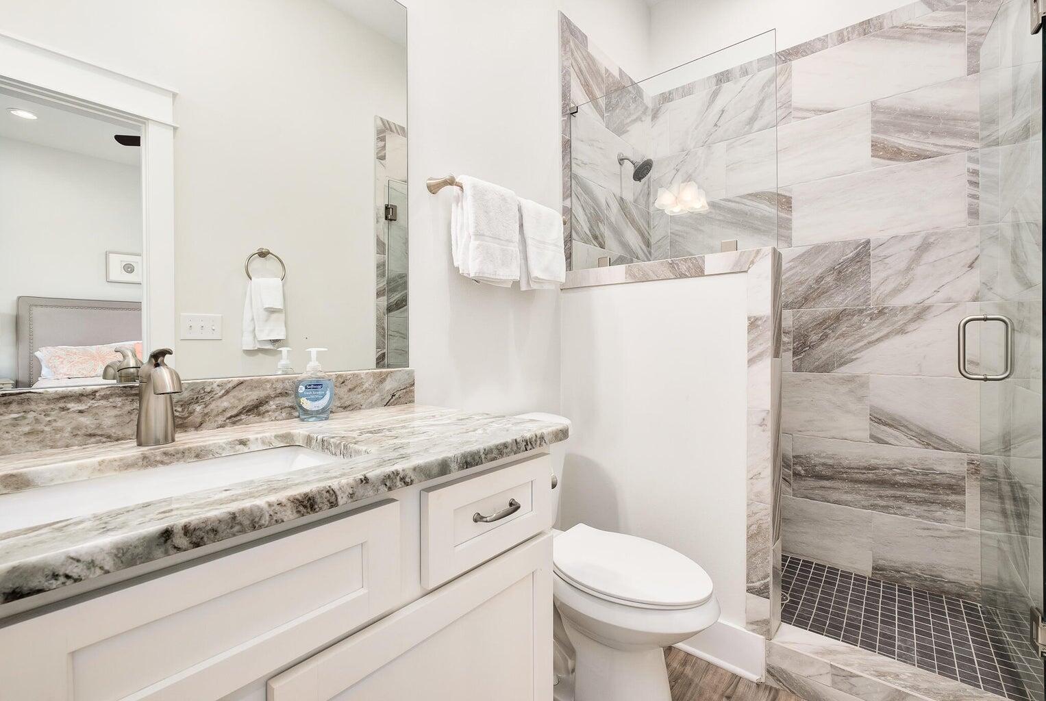 99 Stingray Street Destin, FL 32541 - Photo 24 of 28 a bathroom with a granite countertop sink toilet and shower