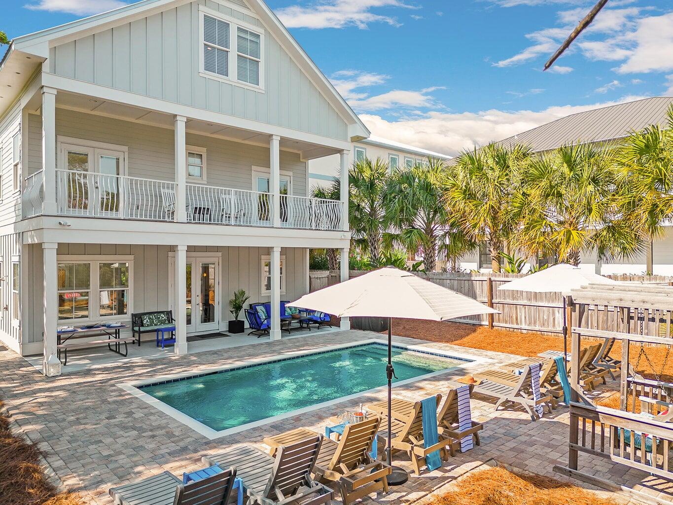 99 Stingray Street Destin, FL 32541 - Photo 3 of 28 a view of a patio with table and chairs under an umbrella