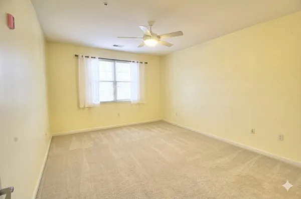 an empty room with a empty space and a window