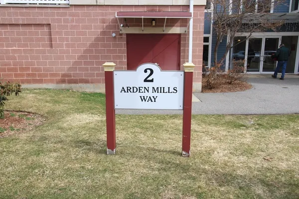 a sign board with brick walls