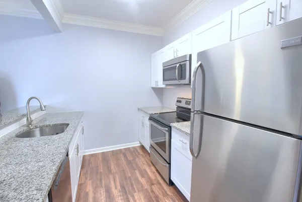a kitchen with stainless steel appliances granite countertop a refrigerator and a sink