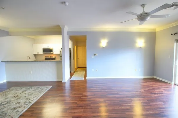 a view of a hallway with wooden floor