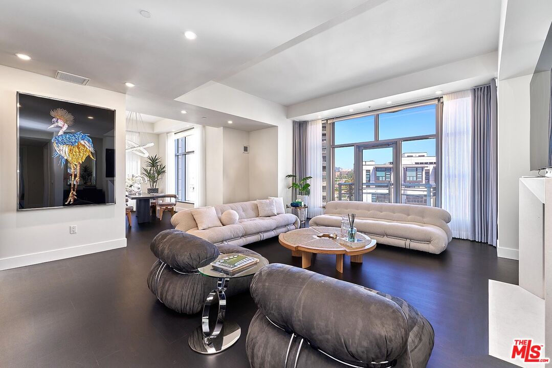 10776 Wilshire Boulevard, Unit 603 Los Angeles, CA 90024 - Photo 14 of 37 a living room with furniture and wooden floor