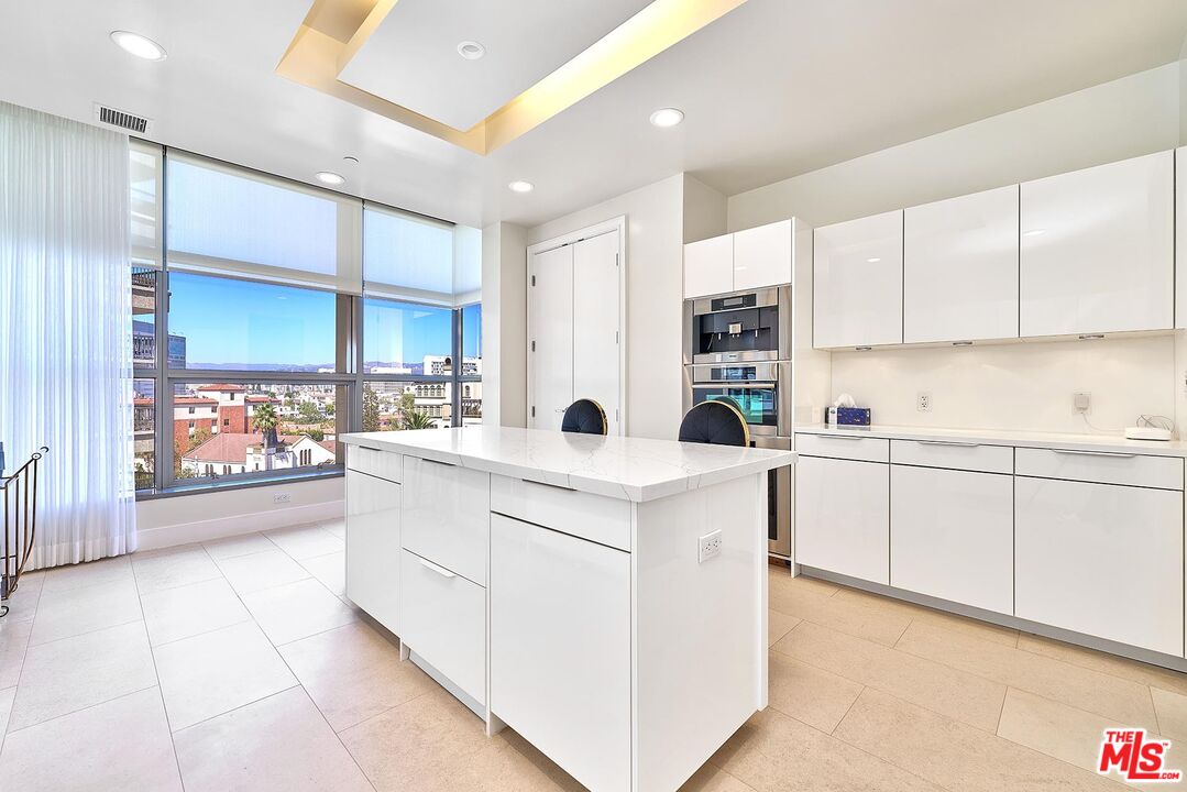 10776 Wilshire Boulevard, Unit 603 Los Angeles, CA 90024 - Photo 20 of 37 a kitchen with counter top space and cabinets
