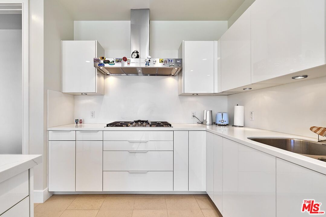 10776 Wilshire Boulevard, Unit 603 Los Angeles, CA 90024 - Photo 24 of 37 a kitchen with stainless steel appliances a sink stove and cabinets