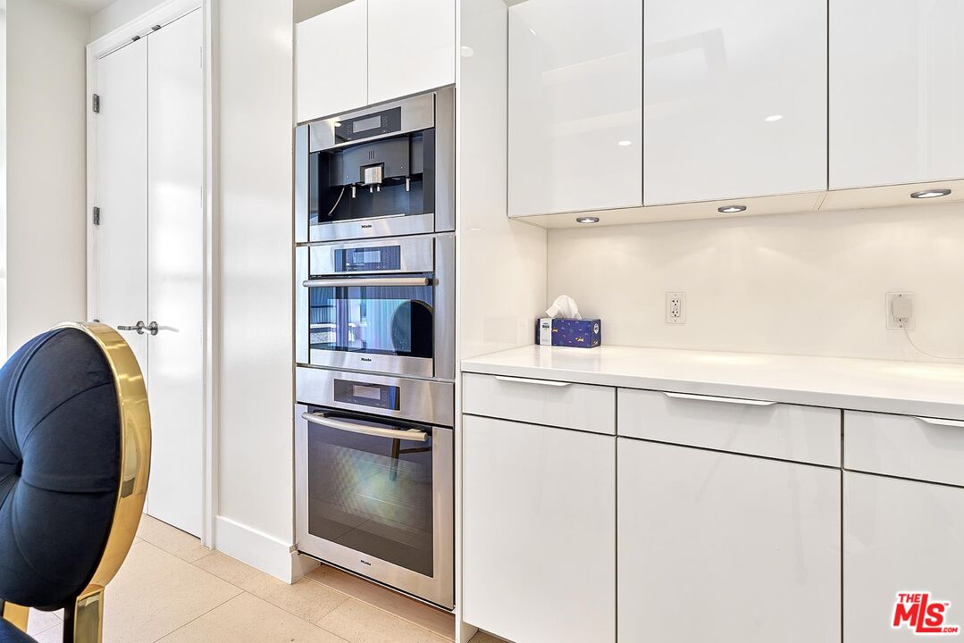 10776 Wilshire Boulevard, Unit 603 Los Angeles, CA 90024 - Photo 25 of 37 a kitchen with stainless steel appliances a refrigerator and a stove top oven