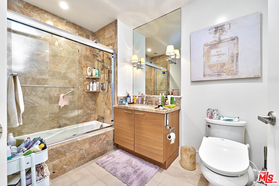 10776 Wilshire Boulevard, Unit 603 Los Angeles, CA 90024 - Photo 28 of 37 a bathroom with a sink a toilet and shower