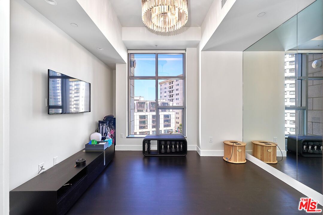 10776 Wilshire Boulevard, Unit 603 Los Angeles, CA 90024 - Photo 30 of 37 a living room with furniture and a wooden floor