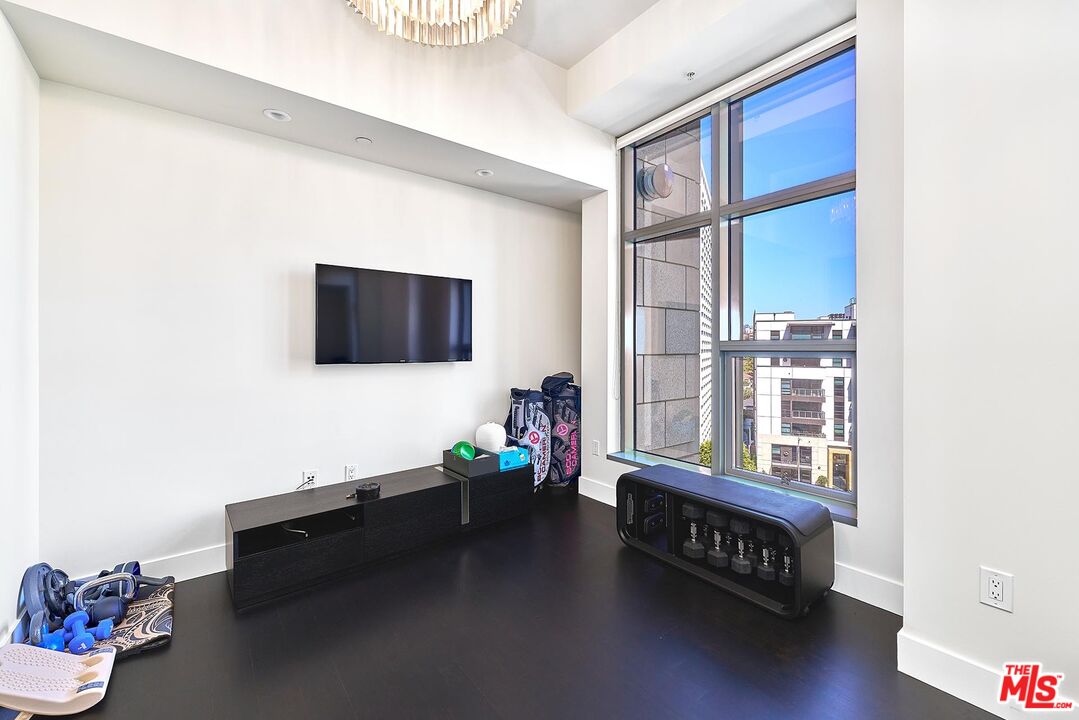 10776 Wilshire Boulevard, Unit 603 Los Angeles, CA 90024 - Photo 31 of 37 a living room with furniture and a flat screen tv