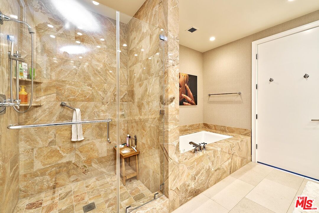 10776 Wilshire Boulevard, Unit 603 Los Angeles, CA 90024 - Photo 36 of 37 a bathroom with a bathtub and shower