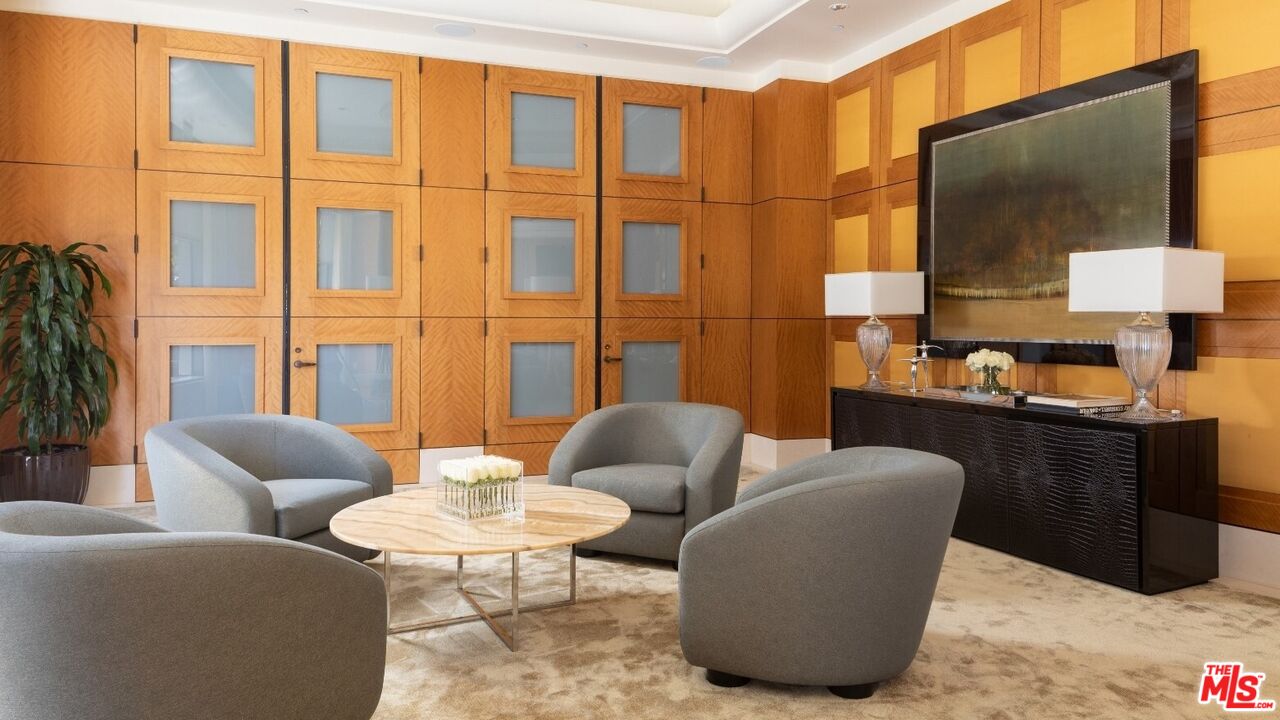 10776 Wilshire Boulevard, Unit 603 Los Angeles, CA 90024 - Photo 4 of 37 a living room with furniture and a flat screen tv