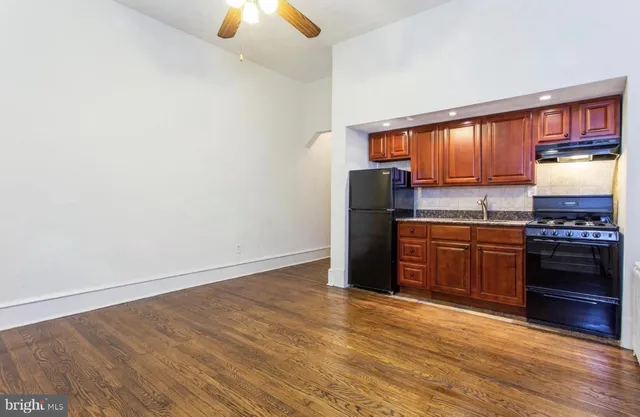 a kitchen with stainless steel appliances a refrigerator and a stove top oven