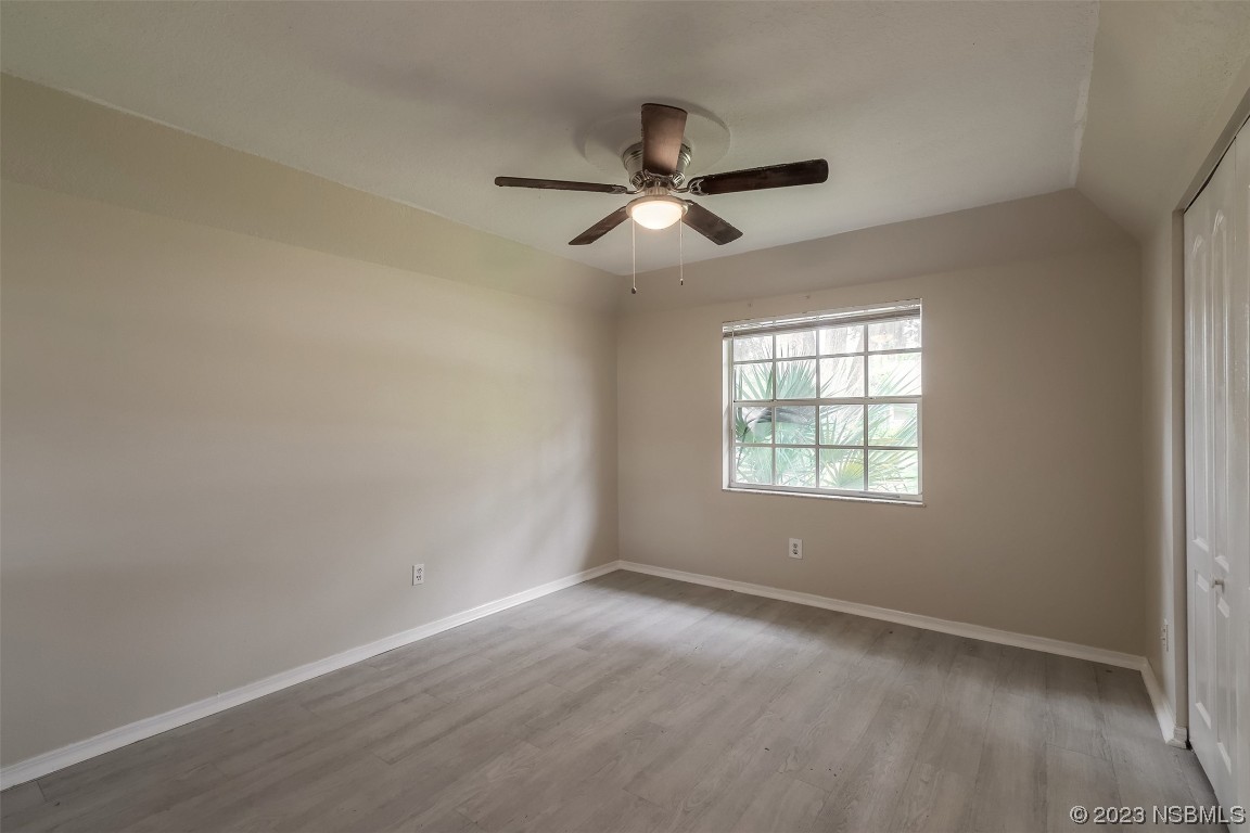 2311 Pine Tree Drive Edgewater, FL 32141 - Photo 12 of 32 wooden floor in an empty room with a window