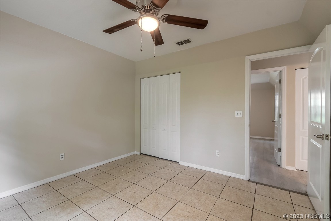 2311 Pine Tree Drive Edgewater, FL 32141 - Photo 15 of 32 an empty room with closet and a chandelier fan