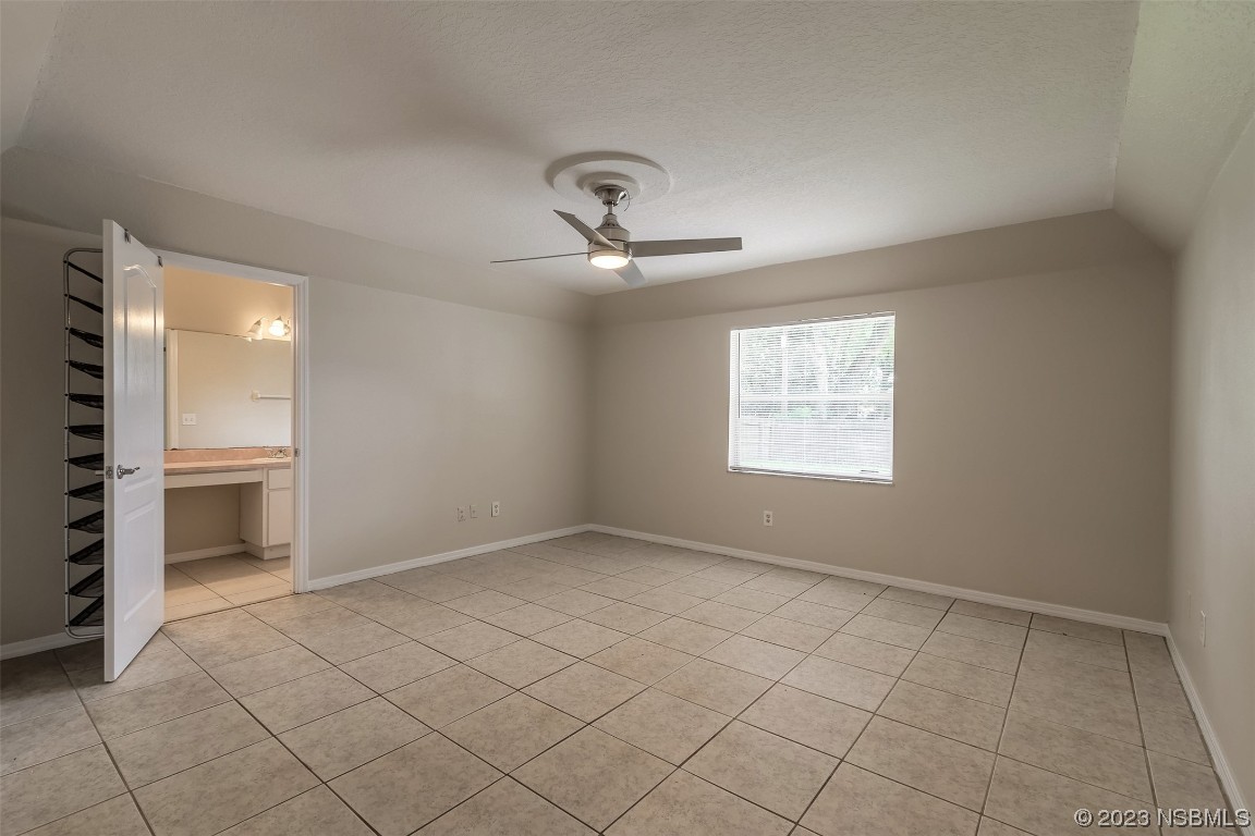 2311 Pine Tree Drive Edgewater, FL 32141 - Photo 16 of 32 an empty room with windows and ceiling fan